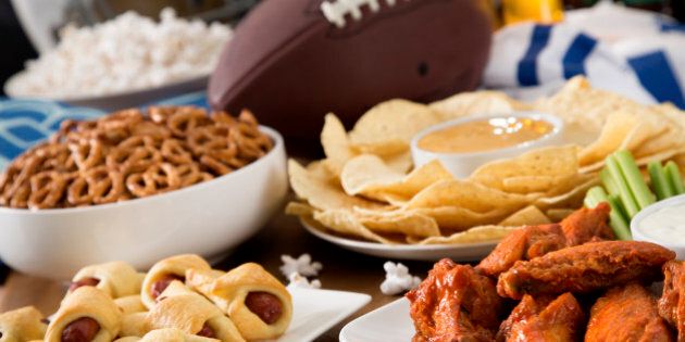 Hot wings, nachos, pigs in a blanket, beer, and popcorn, a tailgate party spread. Please see my portfolio for other food and drink images.