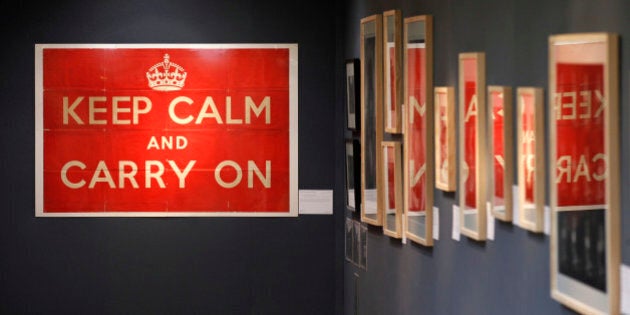 An original 1939 Ministry of Information 'Keep Calm and Carry On' poster, left, is seen on display at Christie's auction house in London, Thursday, Aug. 30, 2012. The poster is to be auctioned in 'The London Sale' on Sept. 3 as is expected to realise a price of 800 to 1,200 pounds (US$1,267 to 1,900 or euro1,010 to 1,515 euro). (AP Photo/Sang Tan)