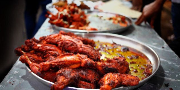 Display of chicken tandoor at food stalls outside Jamiatul Qureshi Masjid Camp, Pune(India). During ramadan there will be food stalls selling variety of snacks to break the ramadan fasting. It becomes compulsory for Muslims to start fasting during ramadan when they reach puberty.