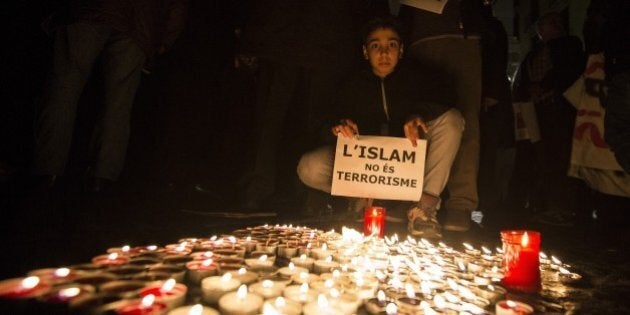 BARCELONA, SPAIN - NOVEMBER 16: Muslims from Barcelona gather to condemn Friday terror attacks in Paris by lighting candles at Placa Sant Jaume in Barcelona, Spain on November 16, 2015. (Photo by Albert Llop/Anadolu Agency/Getty Images)