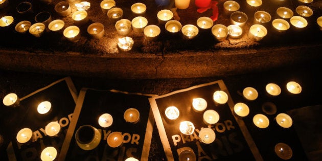 SHANGHAI, SHANGHAI - NOVEMBER 16: (CHINA OUT) Candles are seen in a memorial tribute to the victims in French terror attack at the French Shanghai Consulate on November 16, 2015 in Shanghai, China. French suffered savage terror attach Friday night at Stade de France and a central restaurant as well as several other places which caused at least 128 dead, with 250 people wounded, 99 in critical situation, said local media. (Photo by ChinaFotoPress/ChinaFotoPress via Getty Images)