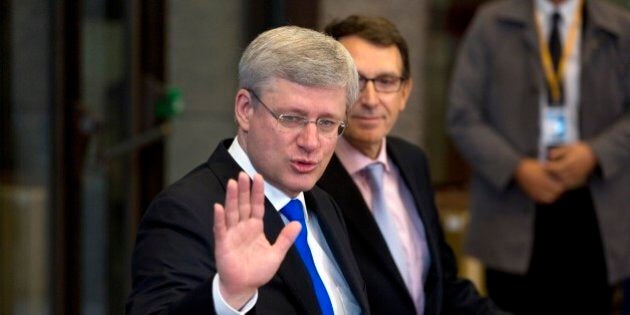 Canadian Prime Minister Stephen Harper waves as he arrives for a G7 summit at the EU Council building in Brussels on Thursday, June 5, 2014. The leaders of the G-7 group of major economies center their effort during the concluding day of their summit on spurring growth and jobs in an attempt to reinforce a rebound from the global financial crisis. (AP Photo/Virginia Mayo)