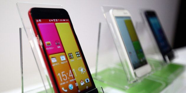 HTC J butterfly smartphones, manufactured by HTC Corp., are displayed during the unveiling in Tokyo, Japan, on Tuesday, Aug. 19, 2014. The smartphone, co-developed with KDDI Corp., goes on sale on Aug. 29 in Japan. Photographer: Tomohiro Ohsumi/Bloomberg via Getty Images