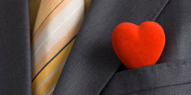 A red heart in a suit pocket representing the business card of modern Mr. Valentine.