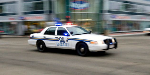 EDMONTON, CANADA - OCTOBER 21: A sheriff's car speeds through the downtown streets on its way to a hostage situation at the Workers' Compensation Board building on October 21, 2009 in Edmonton, Alberta, Canada. The armed man who may be holding two hostages and have had up to 11 earlier in the day is a disgruntled workers' compensation claimant. (Photo by Dylan Lynch/Getty Images)