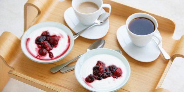 Breakfast tray with coffee and berries with cream