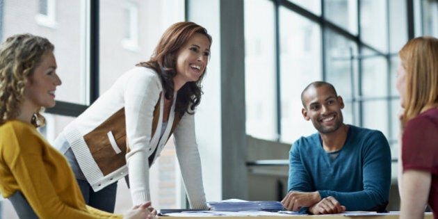 Smiling coworkers in meeting in modern studio