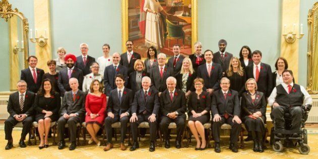 Canadian Governor General David Johnston and Prime Minister Justin Trudeau pose for a photo with Trudeau's cabinet after being sworn in at Rideau Hall in Ottawa, Ontario,, November 4, 2015. AFP PHOTO/ GEOFF ROBINS (Photo credit should read GEOFF ROBINS/AFP/Getty Images)