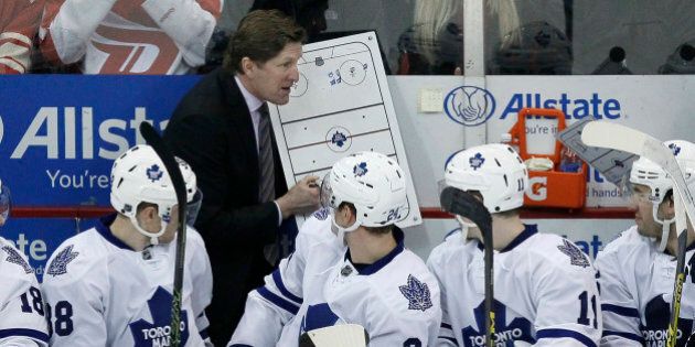 Toronto Maple Leafs head coach Mike Babcock draws up a play for Toronto Maple Leafs' Colin Greening (38), Peter Holland and Zach Hyman (11) during the third period of an NHL hockey game against the Detroit Red Wings Sunday, March 13, 2016, in Detroit. (AP Photo/Duane Burleson)