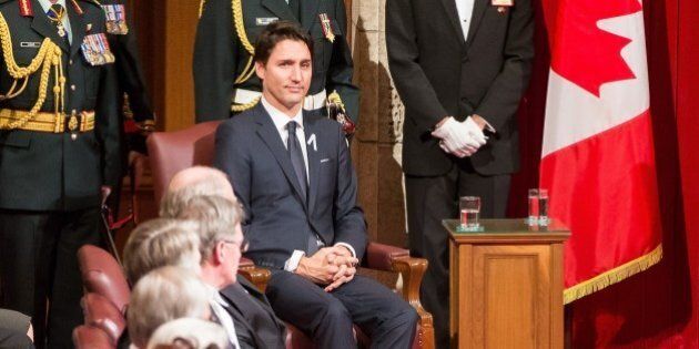 Prime Minister Justin Trudeau listens as Governor General David Johnston delivers the Speech from the Throne to the start Canada's 42nd parliament Ottawa, Canada on December 4, 2015. AFP PHOTO/GEOFF ROBINS / AFP / GEOFF ROBINS (Photo credit should read GEOFF ROBINS/AFP/Getty Images)
