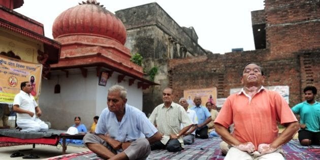 Indians yoga practitioners take part in a workshop at a temple on the banks of the River Ganges in Allahabad on June 20, 2016, ahead of International Yoga Day.International Yoga Day is celebrated on June 21 each year. / AFP / SANJAY KANOJIA (Photo credit should read SANJAY KANOJIA/AFP/Getty Images)