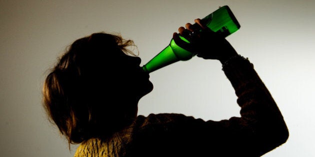 PICTURE POSED BY MODEL A woman drinking alcohol.