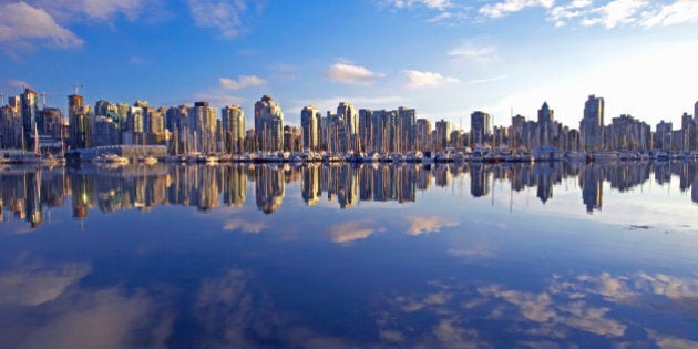 Canada, Vancouver apartment buildings reflecting in lake