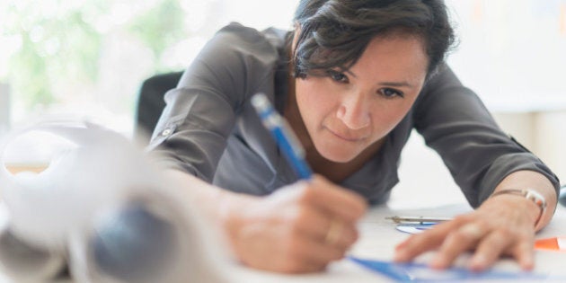 USA, New Jersey, Jersey City, Woman drawing blueprints