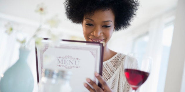 African American people reading menu at restaurant