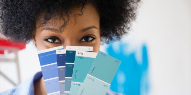 African American woman holding paint swatches