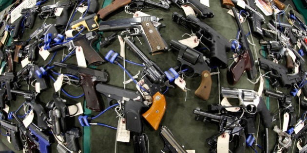 FILE PHOTO: Guns are displayed at the Rocky Mountain Gun Show in Sandy, Utah, U.S. on Saturday, Jan. 7, 2012. The National Rifle Association called for stationing police officers in schools as the proper response to the Dec. 14, 2012 school shooting in Connecticut and blamed âblood-soaked filmsâ and video games for the violence. Photographer: George Frey/Bloomberg via Getty Images