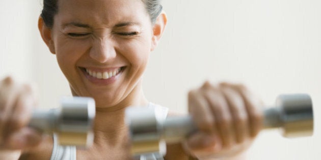 Hispanic woman exercising with weights