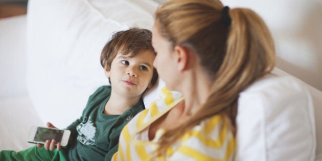 Small boy talking to his mother