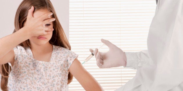 Doctor giving an injecting to a girl