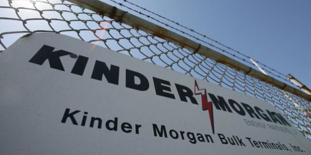 UNITED STATES - AUGUST 28: A sign hangs from a fence at a Kinder Morgan facility at the harbor in Los Angeles, California, August 28, 2006. Kinder Morgan Inc., operator of 43,000 miles of North American oil and gas pipelines, agreed to a sweetened $15 billion takeover bid from a group led by co- founder Richard Kinder that will take the company private. (Photo by Tim Rue/Bloomberg via Getty Images)