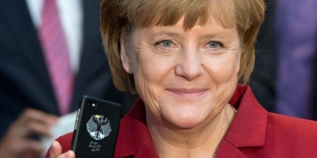 German Chancellor Angela Merkel holds a tapping proof BlackBerry mobile device at the stand of Secusmart as she tours the CeBIT high-tech fair during the opening event of the world's largest computer expo on March 5, 2013 in Hanover, central Germany. Poland is this year's partner country of the fair running from March 5 to 9, 2013. AFP PHOTO / JULIAN STRATENSCHULTE GERMANY OUT (Photo credit should read JULIAN STRATENSCHULTE/AFP/Getty Images)