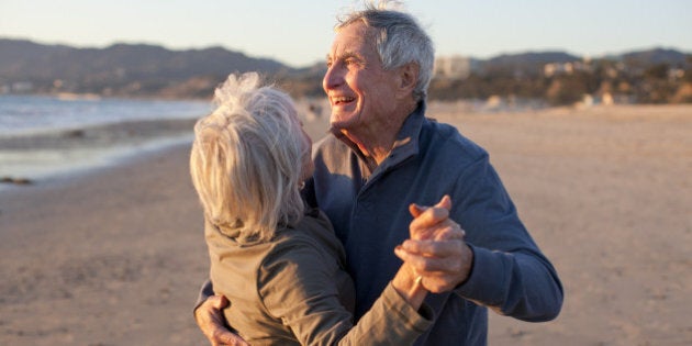 Senior Male and Female Couple Romantic Beach Lifestyle Dancing