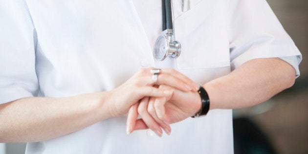 Female doctor checking the time