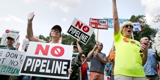 Opponents of a proposed natural gas pipeline protest on Boston Common across from the Statehouse in Boston, Wednesday, July 30, 2014. Energy company Kinder Morgan has proposed the $3.75 billion extension of its northeast pipeline through Massachusetts and says will provide clean-burning natural gas to the northeast. (AP Photo/Charles Krupa)