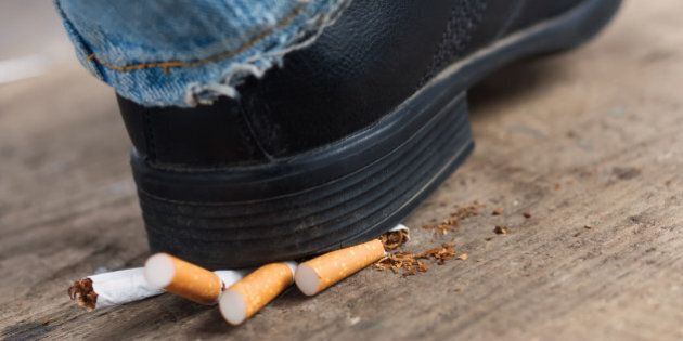 Man quit smoking and crush cigarettes foot