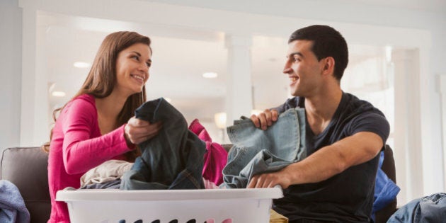 Couple sorting laundry together