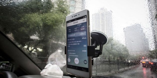 The Didi Chuxing application is displayed on a smartphone screen onboard a vehicle in Shanghai, China, on Sunday, May 22, 2016. Philippe Laffont's Coatue Management LLC, which manages more than $7 billion, has backed China's biggest ride-hailing app Didi Chuxing as it competes with Uber Technologies Inc. Photographer: Qilai Shen/Bloomberg via Getty Images