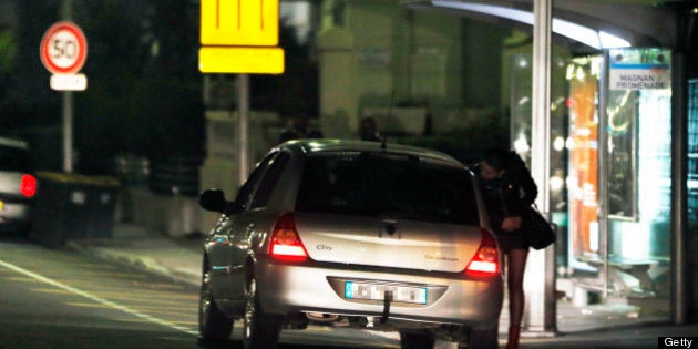 A prostitute speaks with a driver on March 28, 2013 in Nice, southern France. France's Senate will examine today a draft law aimed to abrogate the offense of soliciting clients. The bill should be adopted despite Socialist Party members dissenting on the issue. AFP PHOTO / VALERY HACHE (Photo credit should read VALERY HACHE/AFP/Getty Images)