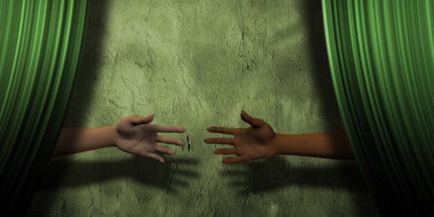 Hands reach behind curtain