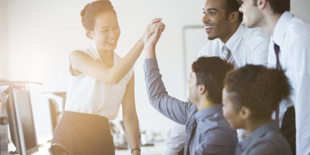 Business people cheering in office