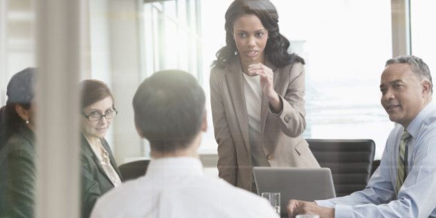 Businesswoman talking to colleagues in meeting