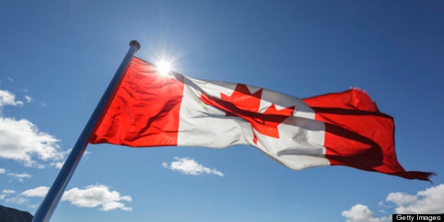 The Canadian Flag flies from the stern of the Uchuck 111 as it traverses Esperanza Inlet, British Columbia, Canada.