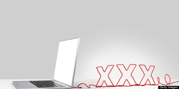 Laptop computer with a red ethernet cable forming 'XXX', coming out of the back on a plain background