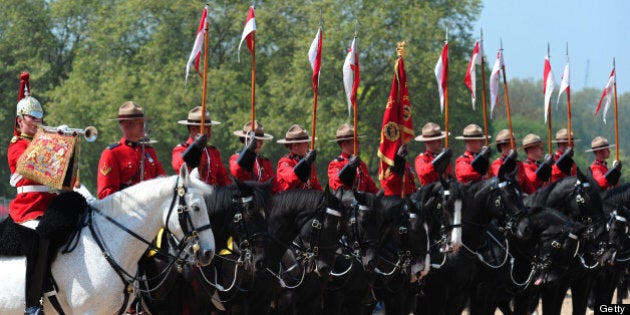 Members of the Royal Canadian Mounted Police (R) parade with British Guards (Far L) on Horse Guards Parade in central London, on May 23, 2012, as the RCMP take part in the 'Changing of the Guard' ceremony. Their participation is part of the Queen's Diamond Jubilee celebrations and will also feature women for the first time. AFP PHOTO / CARL COURT (Photo credit should read CARL COURT/AFP/GettyImages)