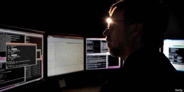 Joe Stewart, director of malware research at Dell SecureWorks, a unit of Dell Inc., works on multiple computer screens at his office in Myrtle Beach, South Carolina, U.S., Friday, Jan. 18, 2013. Stewart, 42, spends his days hunting for Internet spies. Photographer: Stephen Morton/Bloomberg via Getty Images