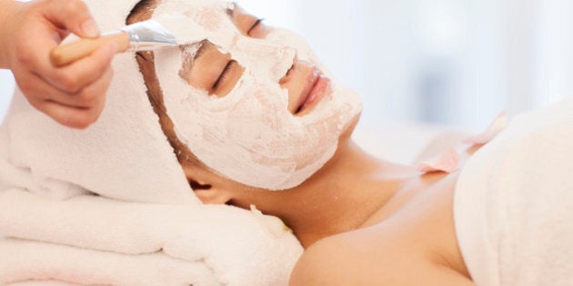 Spa workers wipping mask to an Asian woman's face