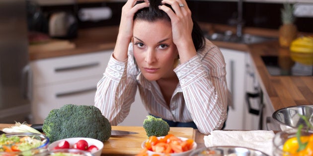 Depressed and sad woman in kitchen