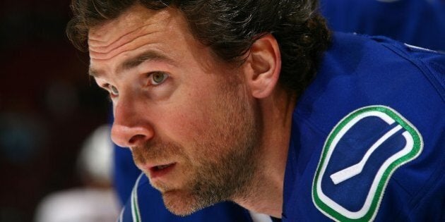 Vancouver Canucks' Trevor Linden, left, is followed by his wife