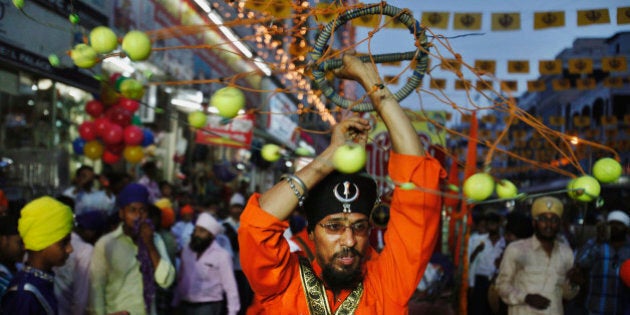 Indian Sikh devotees performs Sikh martial art during a religious procession Khalsa Saajna Divas or Baisakhi festival in Hyderabad, India, Friday, April 13, 2012. Baisakhi is the harvest festival widely celebrated in northern India, especially in the Punjab area. (AP Photo/Mahesh Kumar A.)