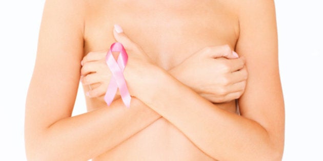 health, medicine, beauty concept - naked woman with breast cancer awareness ribbon