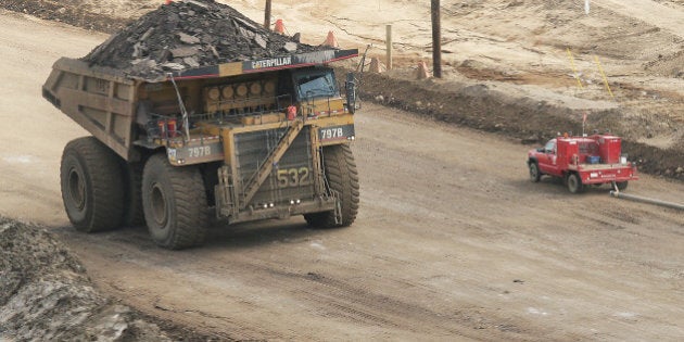 KRT WORLD NEWS STORY SLUGGED: CANADA-OILSANDS KRT PHOTOGRAPH BY CARL PATZEL/KRT (October 5) Smaller vehicles are dwarfed by 797 Heavy hauler trucks that cruise through Syncrude's Canada Aurora Mine site open-pit mining operation, 50 miles north of Fort McMurray, Alberta. Syncrude produces 31% of Canada's crude oil, in the 174 ++billion-barrel oils sand, with that volume projected to increase fourfold by 2015. (Photo by Carl Patzel/MCT/MCT via Getty Images)