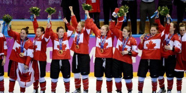 Members of Canada's women hockey team celebrate after they received their gold medals for a 3-2 overtime win over the USA in the women's hockey gold medal game at Winter Olympics in Sochi, Russia, Friday, Feb. 21, 2014. (Chuck Myers/MCT via Getty Images)