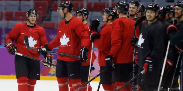 Canada forward Sidney Crosby, left, and other members of the Canadian men's ice hockey team wait at mid ice during a scoring drill during a training session at the 2014 Winter Olympics, Monday, Feb. 10, 2014, in Sochi, Russia. (AP Photo/Julie Jacobson)