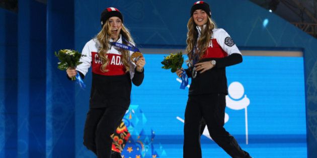 SOCHI, RUSSIA - FEBRUARY 09: Gold medalist Justine Dufour-Lapointe (L) and silver medalist Chloe Dufour-Lapointe of Canada celebrate during the medal ceremony for the Ladies Moguls Final 3 on day 2 of the Sochi 2014 Winter Olympics at Medals Plaza on February 9, 2014 in Sochi, . (Photo by Streeter Lecka/Getty Images)