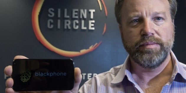 Mike Janke, CEO & Co-Founder of Silent Circle, makers of encrypted communications providing secure multiplatform communication services for mobile devices, desktop and email, holds a typical smart phone similar in styling to a new encrypted smartphone called, 'The Blackphone', Silent Circle will be selling soon, seen here, January 16, 2014, at his National Harbor, Maryland office. The actual Blackphone that Silent Circle will be selling is under wraps until it's official release date and will cost about what a unlocked Samsung Galaxy S4 or unlocked IPhone typically costs. AFP PHOTO/Paul J. Richards (Photo credit should read PAUL J. RICHARDS/AFP/Getty Images)